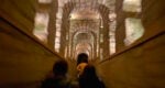 a person walking underground in the Paris catacombs