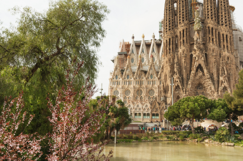 A lake in front of a huge church with many spires