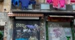 closed shops with washing hanging above them