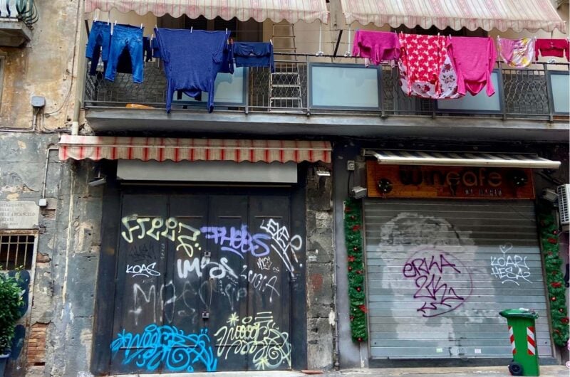 closed shops with washing hanging above them