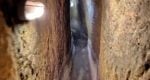 a narrow passage carved underground