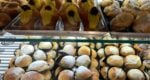 rows of cakes displayed in a bakery