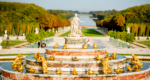 A grand fountain in the Gardens of Versailles with gold figures and many frogs