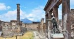 ruins in pompeii with mountains and old structures