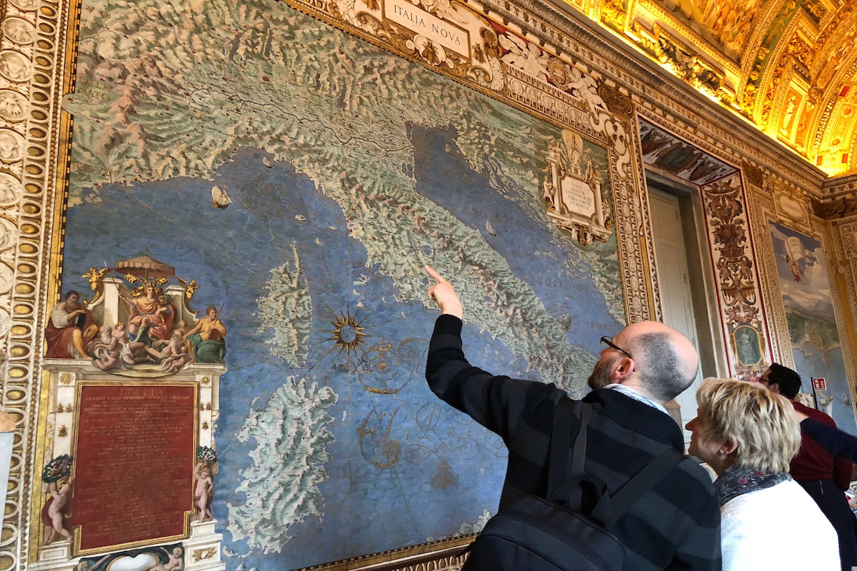 a man points at a map of Italy