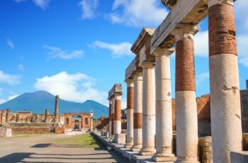 Pompeii columns and Mt Vesuvius in background