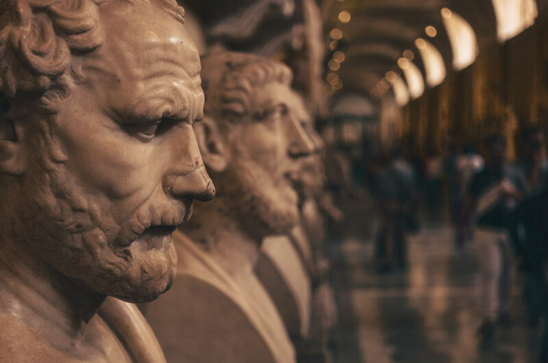 a row of ancient busts in a museum
