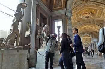 people looking at a statue in a museum