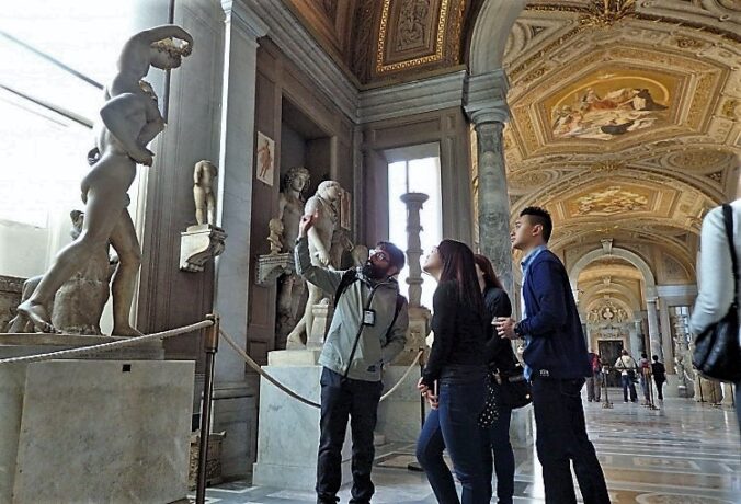 people looking at a statue in a museum