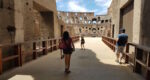 a person entering the arena at the Colosseum in Rome