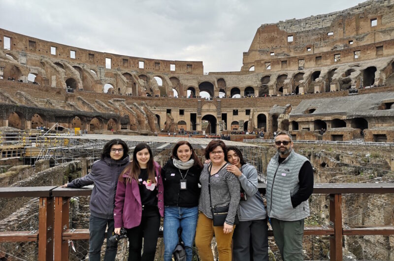 a group of tourists inside the Colosseum