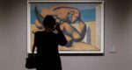 Person takes a photo of a Picasso painting at the museum in Barcelona.