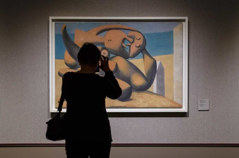 Person takes a photo of a Picasso painting at the museum in Barcelona.