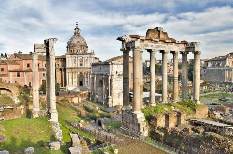 a view of ancient ruins of temples and arches in the Roman Forum