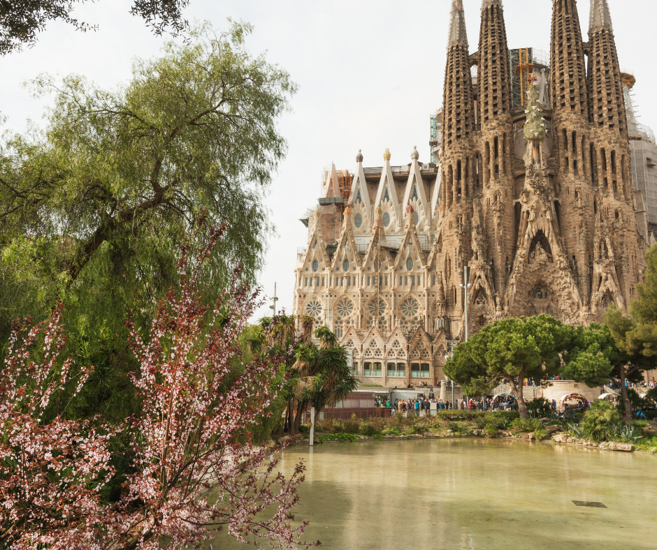 A lake in front of a huge church with many spires