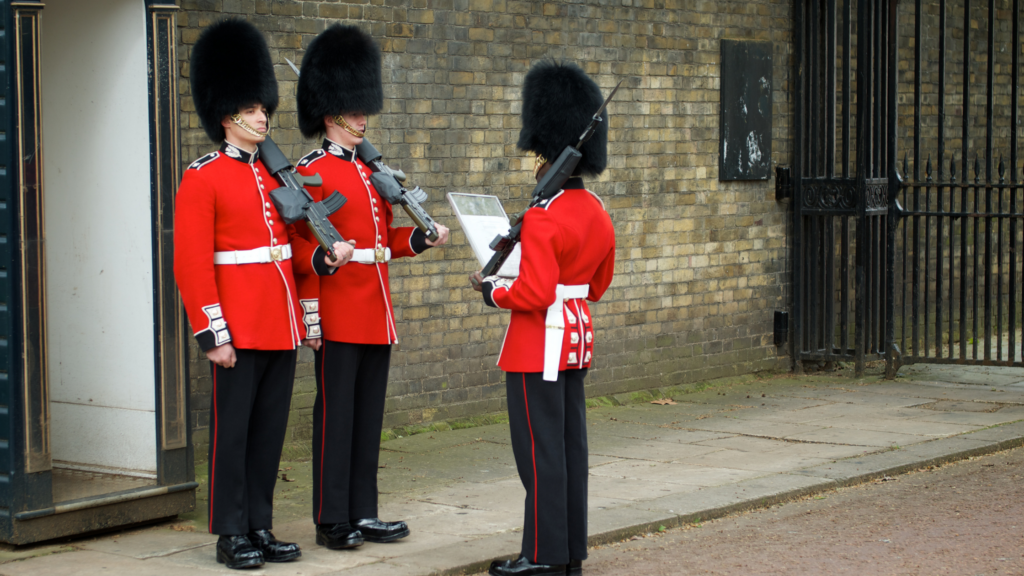 2 Queen's guards receiving orders at Buckingham Palace