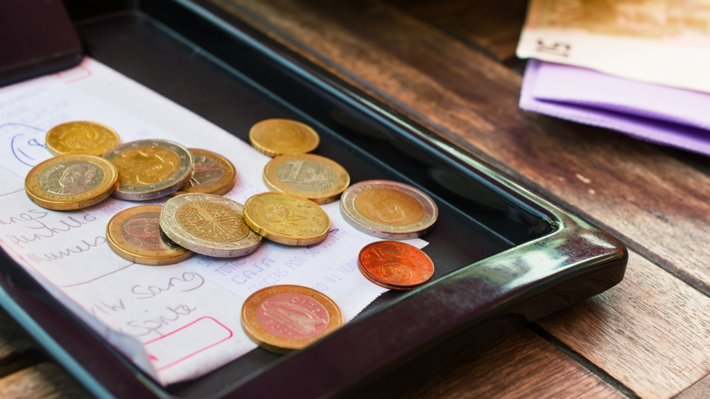 euro coins as a tip on a restaurant bill