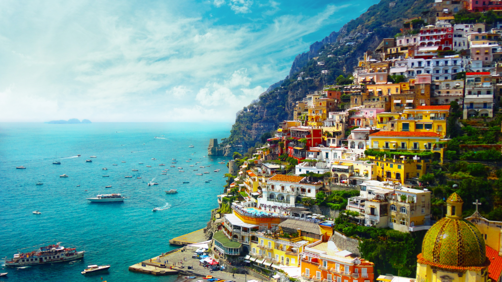 A town of colored houses on a hillside in front of the sea in Italy