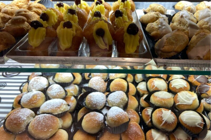rows of cakes displayed in a bakery