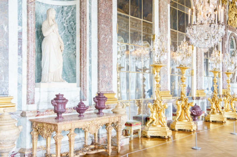 The Hall of Mirrors, Versailles. Large gold candlesticks in front of a wall of mirrors