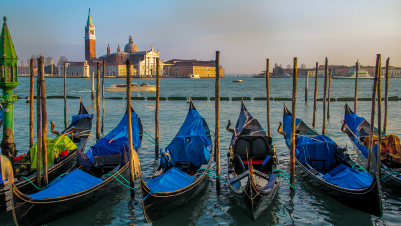 a row of gondolas in Venice, Italy