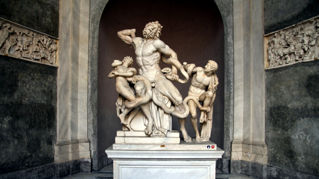 an sculpture of a man and 2 boys being attacked by a snake