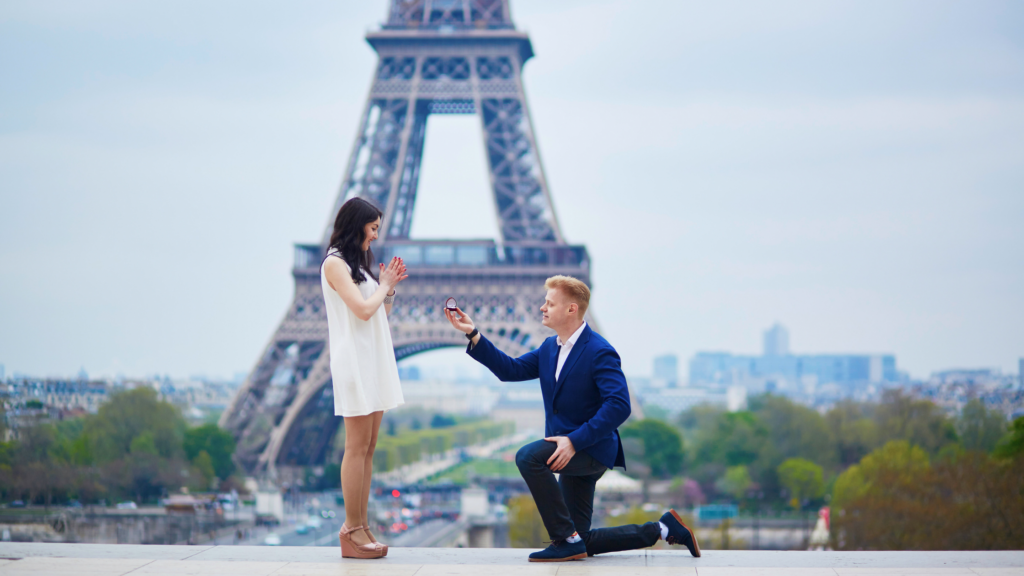 a man proposing to a woman in front of the Eiffel Tower