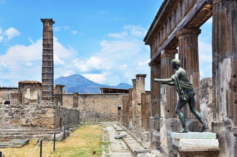 ruins in pompeii with mountains and old structures